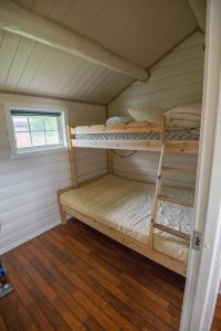 two bunk beds in a room with a window at Fagervik Camping in Tresfjord