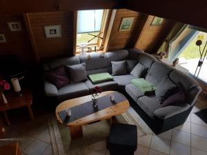 a living room with a couch and a coffee table at Ferienhaus Familie Mischkies in Damp