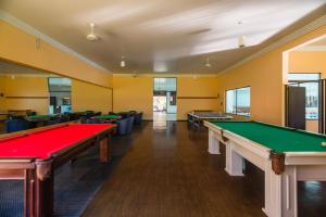 a billiard room with several tables and couches at Estância Ribeirão Grande in Jaraguá do Sul