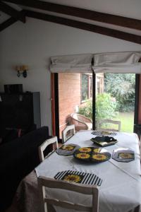 a dining room table with plates of food on it at Cabañas Lomas del Lago in Frutillar