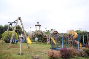a playground in a park with a slide at Cabañas Lomas del Lago in Frutillar