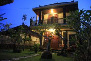 ein Haus mit Balkon in der Nacht in der Unterkunft Pondok Gepokan Homestay in Ubud
