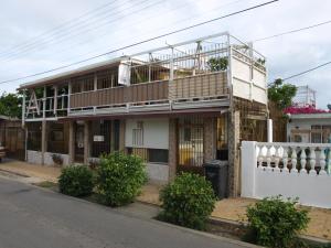 
a large building with a lot of windows on the side of the street at A1 Apartments Aruba in Oranjestad
