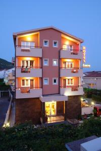 a large apartment building with lights on at Hotel Fineso in Budva