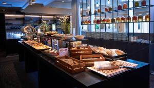a bakery with a buffet of bread and pastries at Hoje Taastrup Hotel Copenhagen West, a member of Radisson Individuals in Tåstrup