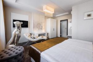 A bed or beds in a room at RQ Boutique & Unique Hotel