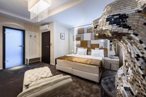 A bed or beds in a room at RQ Boutique & Unique Hotel