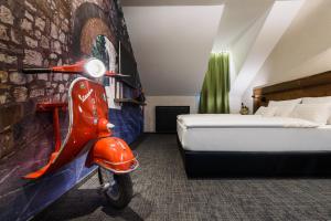 A bed or beds in a room at RQ Boutique & Unique Hotel