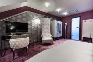 A bed or beds in a room at RQ Boutique & Unique Hotel