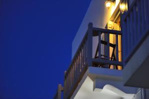 a building with a clock on the top of it at Galini Hotel in Mikonos