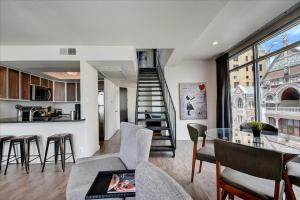 a living room with a kitchen and a stairway at Littlefield Lofts #701 in Austin