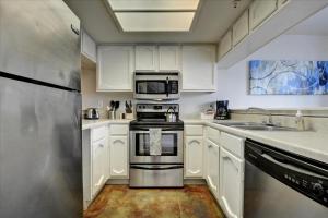 a kitchen with white cabinets and a stainless steel appliance at Littlefield Lofts #302 in Austin