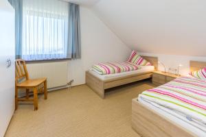 A bed or beds in a room at Haus Margit