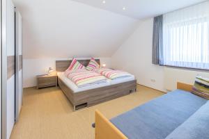 A bed or beds in a room at Haus Margit