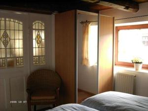 a bedroom with a bed and stained glass windows at Hackerhof-Ostwohnung in Morsum