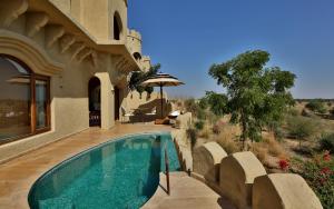 a swimming pool in the middle of a house at Mihir Garh in Rohat