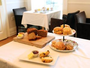 a table with two plates of muffins and other desserts at An Sugan Guesthouse in Clonakilty