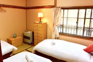 Letto o letti in una camera di Mojo Lodge Hakuba