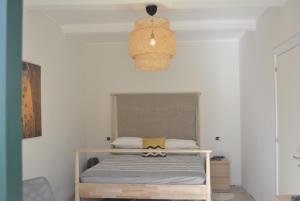 a bedroom with a bed and a pendant light at Casa Marina in Scilla