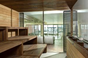 a kitchen with wood paneling and glass walls at Almar Jesolo Resort & Spa in Lido di Jesolo