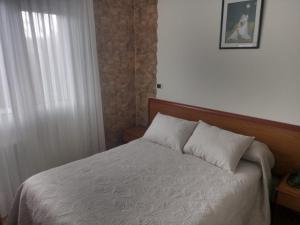 Łóżko lub łóżka w pokoju w obiekcie Arume