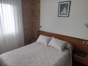 Łóżko lub łóżka w pokoju w obiekcie Arume