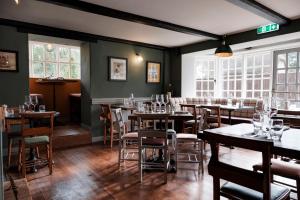 a restaurant with tables and chairs in a room at Castle Inn in West Lulworth