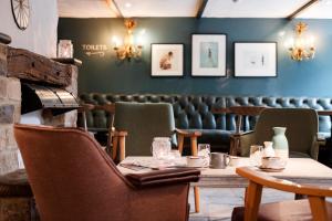 a dining room with a table and chairs at Castle Inn in West Lulworth