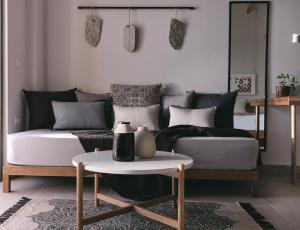 a living room with a couch and a table at Hotel St.John Suites Adults Only in Tsilivi