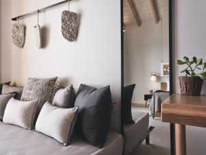 a living room with a couch with pillows at Hotel St.John Suites Adults Only in Tsilivi