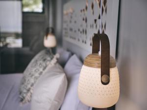 a lamp hanging on a wall next to a couch at Hotel St.John Suites Adults Only in Tsilivi
