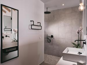 a bathroom with a sink and a mirror at Hotel St.John Suites Adults Only in Tsilivi
