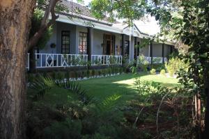 a house with a green lawn in front of it at Halfway House Hotel in Kimberley
