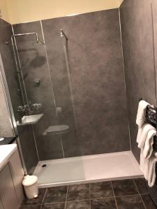 a shower with a glass door in a bathroom at Dryburgh Abbey Hotel in Melrose