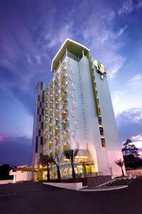 a large building with a person jumping off of it at Shakti Hotel Bandung in Bandung