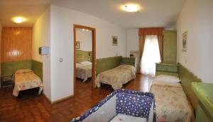 Postel nebo postele na pokoji v ubytování Hotel Piancastello