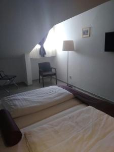 a bedroom with a large bed and a chair at Hotel Biokovo in Makarska