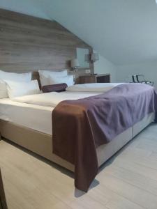 a large white bed in a room with at Hotel Biokovo in Makarska