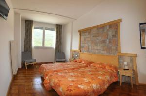 Postel nebo postele na pokoji v ubytování Hotel Piancastello