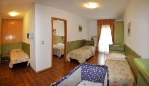 Postel nebo postele na pokoji v ubytování Hotel Piancastello