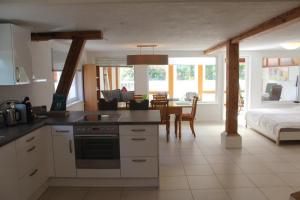 a kitchen with a table and a bed in a room at Ferienwohnung-Dorothe in Rheinau