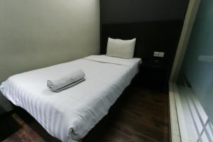 Voodi või voodid majutusasutuse Hotel 99 Bandar Klang (Meru) toas