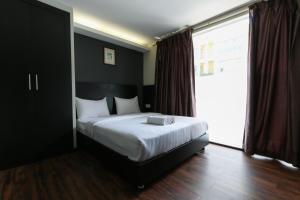 Voodi või voodid majutusasutuse Hotel 99 Bandar Klang (Meru) toas