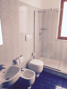 a bathroom with a toilet and a sink and a shower at B&B San Vito in San Vito lo Capo