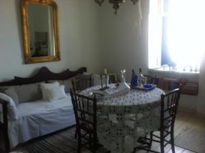 a living room with a table and a couch at Persefonis view house in Glossa