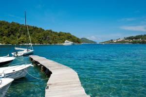 a dock with boats in a large body of water at Persefonis view house in Glossa