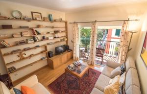 a living room with shelves and a couch and a tv at Funchal Arcadas Apartment by MLV in Funchal