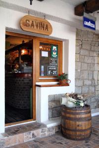 a restaurant with a barrel in front of a building at Apartments Savina in Budva