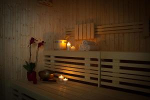 a room with candles and a shelf with a bowl and flowers at Ingrappa Sporthouse in Borso del Grappa