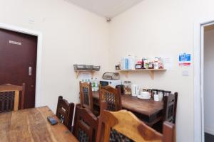a dining room with a long wooden table and chairs at Budget Hostel in Newcastle upon Tyne